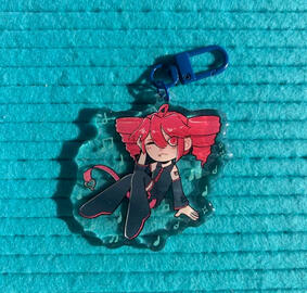Acrylic charm with epoxy front and dark blue clasp